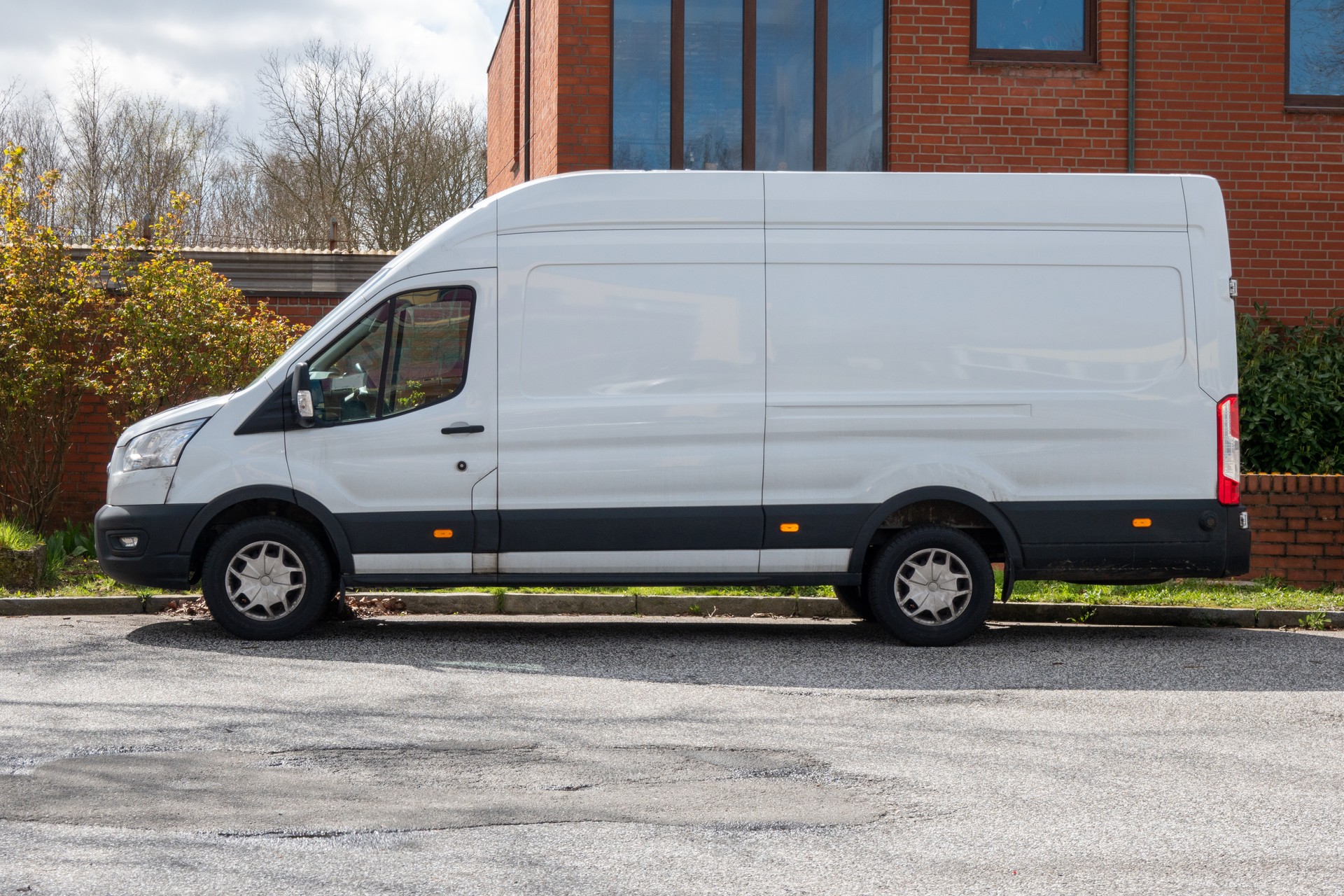 White delivery truck parking in commercial area